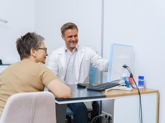 A Health Wellness World doctor welcoming a patient