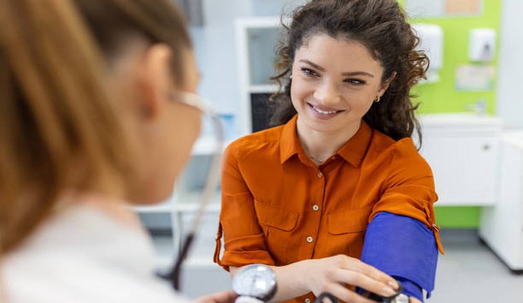 Doctor measuring a patient's blood pressure during a checkup