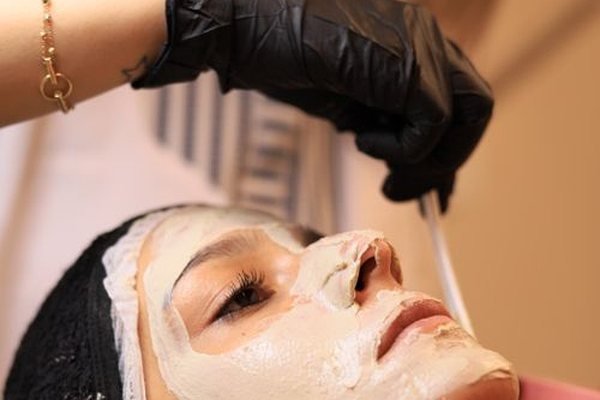 Woman receiving a soothing facial skin treatment