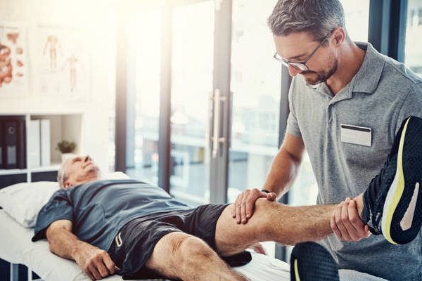Physiotherapist guiding a patient through joint rehabilitation