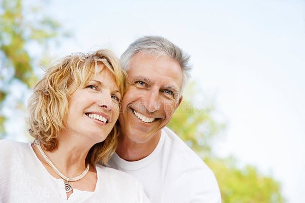 Happy healthy couple smiling outdoors