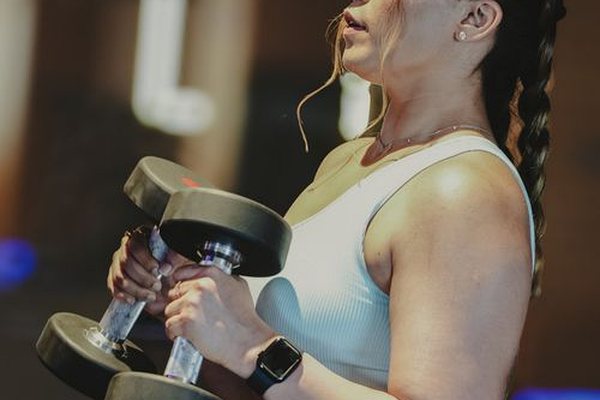 Woman training with dumbbells at the gym
